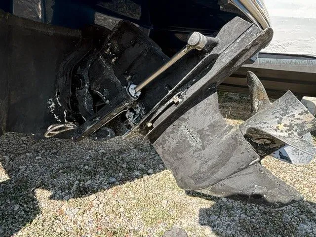 Slide: The Image of Outboard motor of a 2010 Sea Ray 210 Select boat on gravel surface. - 8