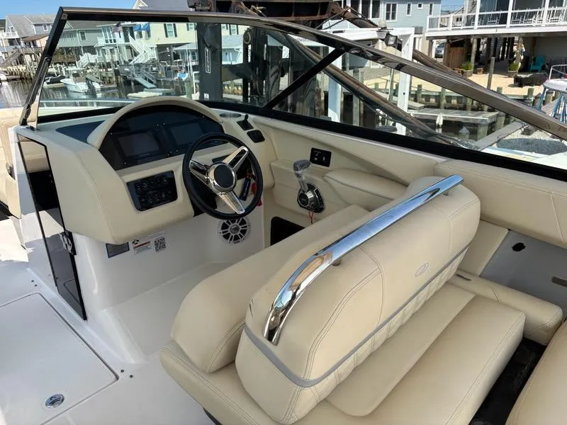 Slide: The Image of 2020 Regal 2800 Bowrider interior with beige seating and modern dashboard controls. - 12