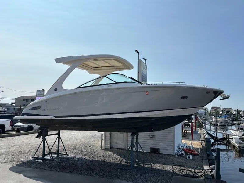 Slide: The Image of 2020 Regal 2800 Bowrider boat on display at a marina. - 2
