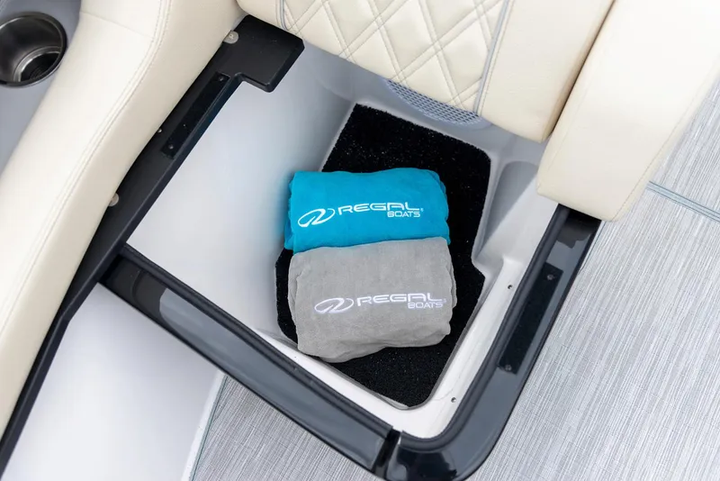Slide: The Image of Manufacturer Provided Image: Storage compartment in 2020 Regal 2800 Bowrider with branded towels. - 25
