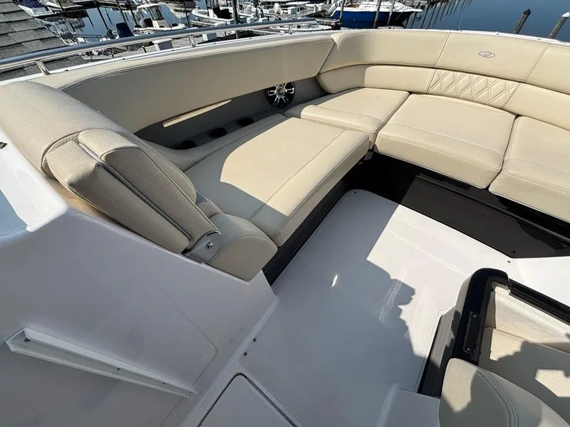 Slide: The Image of 2020 Regal 2800 Bowrider with beige seating, docked at a marina. - 6