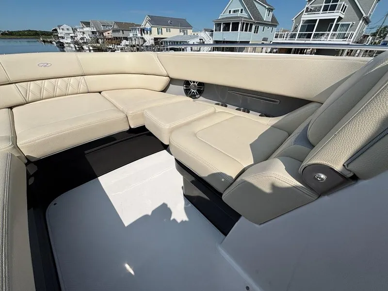 Slide: The Image of Luxurious seating on a 2020 Regal 2800 Bowrider boat, with waterfront homes in the background. - 7
