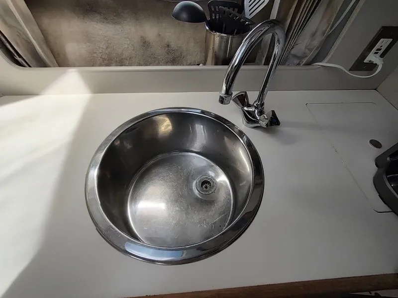 Slide: The Image of Stainless steel sink and faucet in 1992 Carver 36 Aft Cabin boat kitchen. - 42