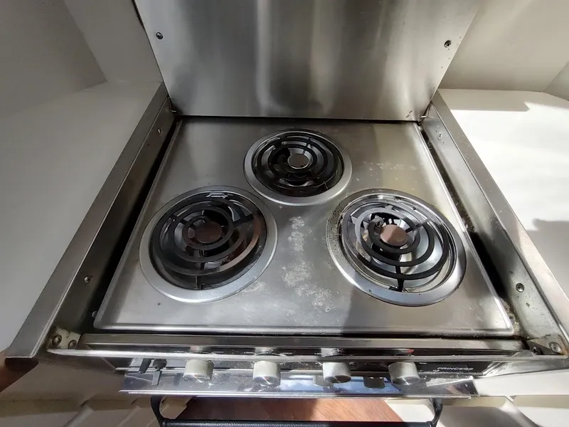 Slide: The Image of Stainless steel stove with three burners in a 1992 Carver 36 Aft Cabin yacht. - 44