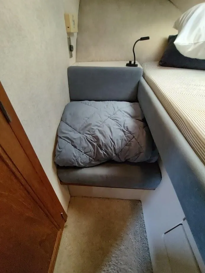 Slide: The Image of Cozy interior of 1992 Carver 36 Aft Cabin with cushioned seating and bedding. - 49