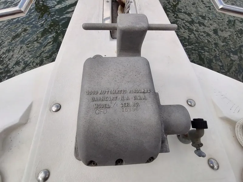 Slide: The Image of 1992 Carver 36 Aft Cabin boat windlass mechanism on deck, near water. - 8