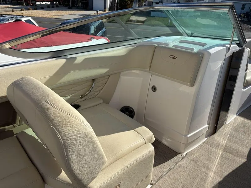 Slide: The Image of 2018 Regal 26 OBX boat interior with beige seating and sleek dashboard design. - 5
