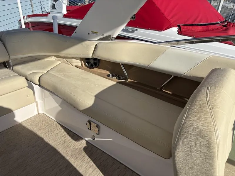 Slide: The Image of Luxurious seating on a 2018 Regal 26 OBX boat with beige upholstery and cup holders. - 6