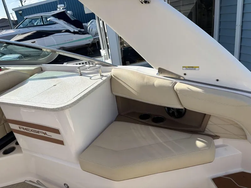Slide: The Image of 2018 Regal 26 OBX boat interior with beige seating and sleek design. - 7