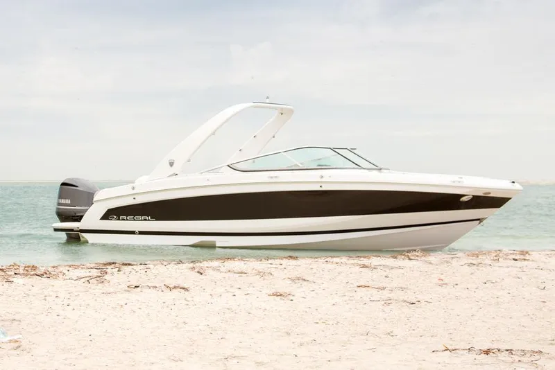 Slide: The Image of Manufacturer Provided Image: 2018 Regal 26 OBX boat on sandy beach with calm sea background. - 9