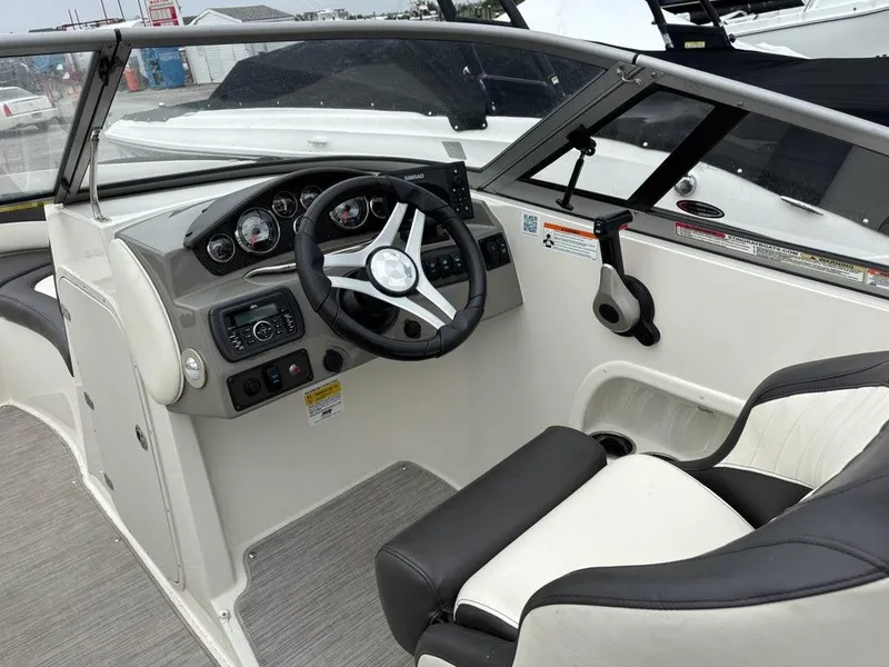 Slide: The Image of 2018 Stingray 214 LR boat interior with steering wheel and dashboard controls. - 11