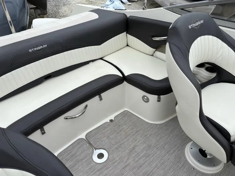 Slide: The Image of 2018 Stingray 214 LR boat interior with black and white seating and modern design. - 18