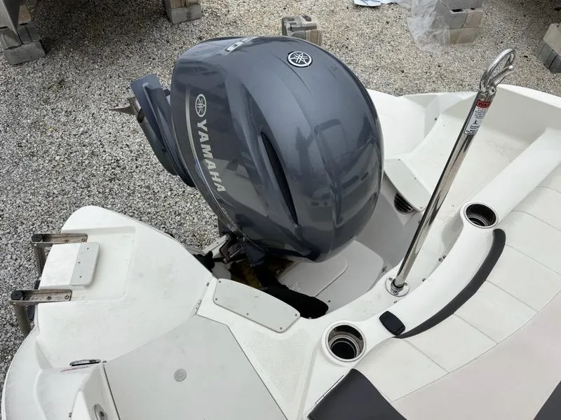 Slide: The Image of 2018 Stingray 214 LR boat with Yamaha outboard motor on gravel surface. - 21