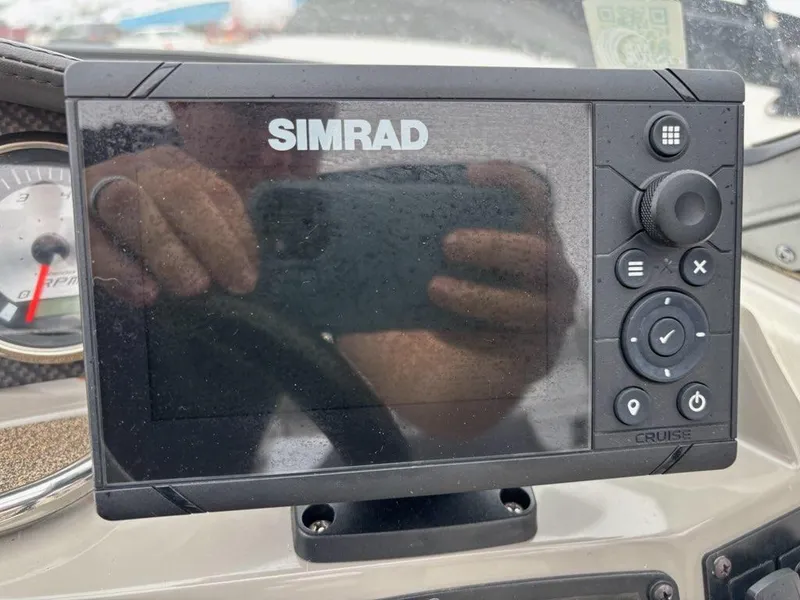 Slide: The Image of Simrad display on 2018 Stingray 214 LR boat dashboard, showing control buttons. - 24