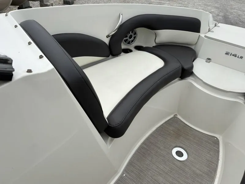Slide: The Image of 2018 Stingray 214 LR boat interior with black and white seating. - 8