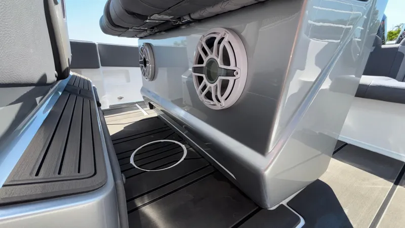 Slide: The Image of 2025 Fountain 34 SC boat interior with sleek seating and built-in speakers. - 14
