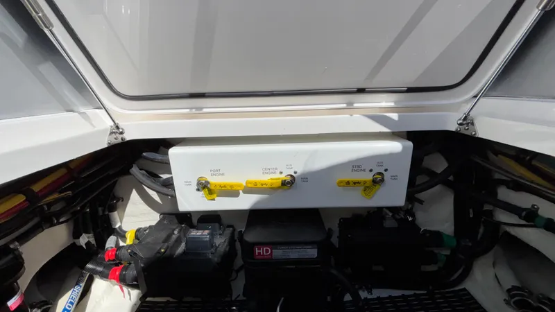 Slide: The Image of Engine compartment of 2025 Fountain 34 SC boat, showing battery and control panel. - 25