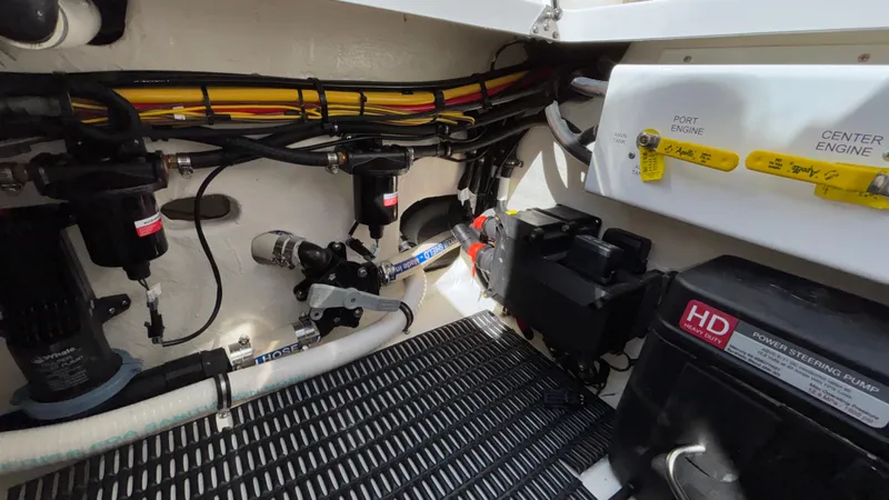 Slide: The Image of Engine compartment of 2025 Fountain 34 SC boat, showing wiring and power steering pump. - 26