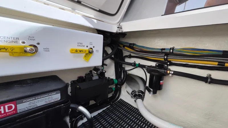 Slide: The Image of Engine compartment of 2025 Fountain 34 SC boat, showing fuel lines and power steering pump. - 27