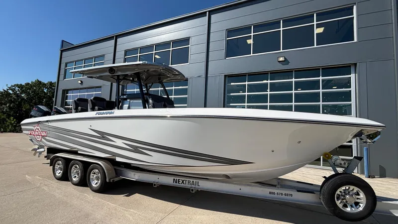 Slide: The Image of 2025 Fountain 34 SC boat on trailer outside modern building. - 3