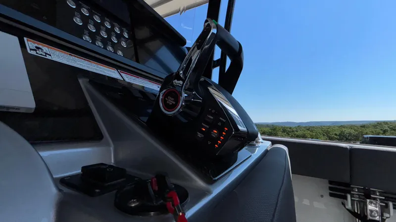 Slide: The Image of Control panel of 2025 Fountain 34 SC boat with scenic view. - 34