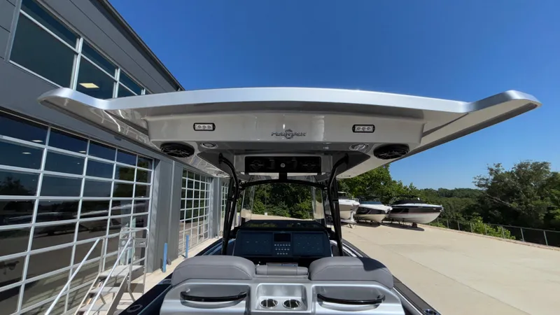 Slide: The Image of 2025 Fountain 34 SC boat with sleek design and advanced features, docked near a modern building. - 38