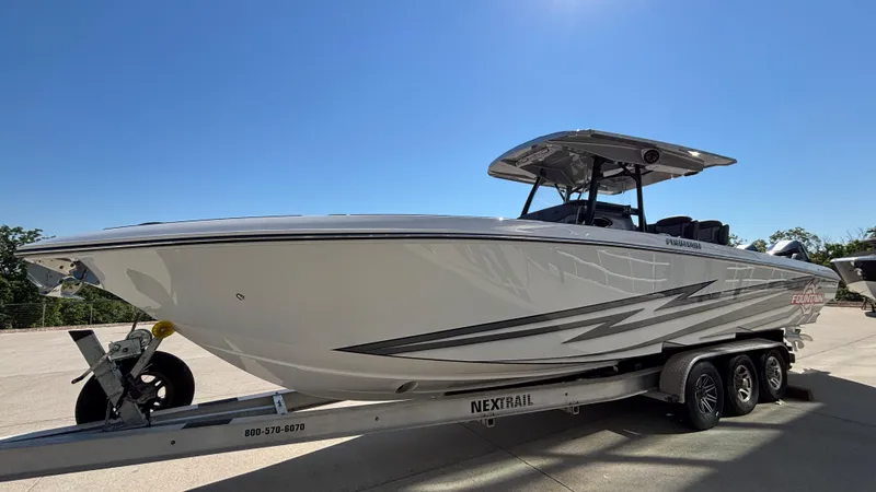 Slide: The Image of 2025 Fountain 34 SC boat on trailer under clear blue sky. - 4