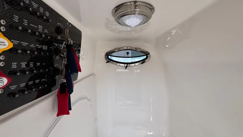 Slide: The Image of Interior of 2025 Fountain 34 SC boat with control panel and porthole. - 44