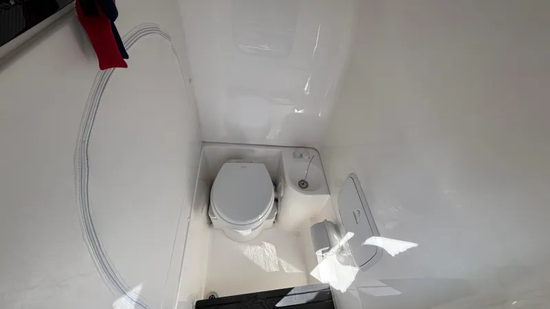 Slide: The Image of 2025 Fountain 34 SC boat interior with modern white bathroom and toilet. - 45