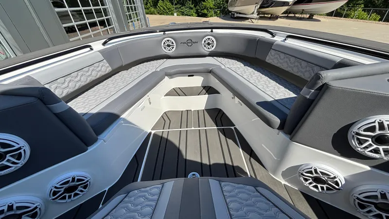 Slide: The Image of 2025 Fountain 34 SC boat interior with gray seating and multiple speakers. - 48