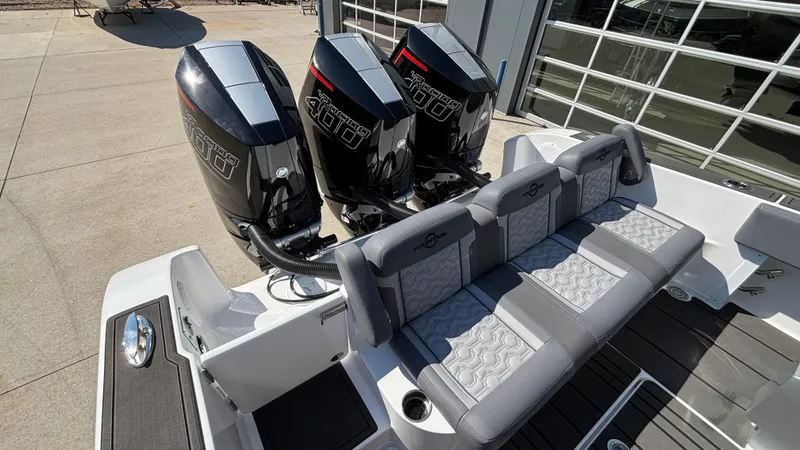Slide: The Image of 2025 Fountain 34 SC boat with triple outboard engines and stylish seating. - 7