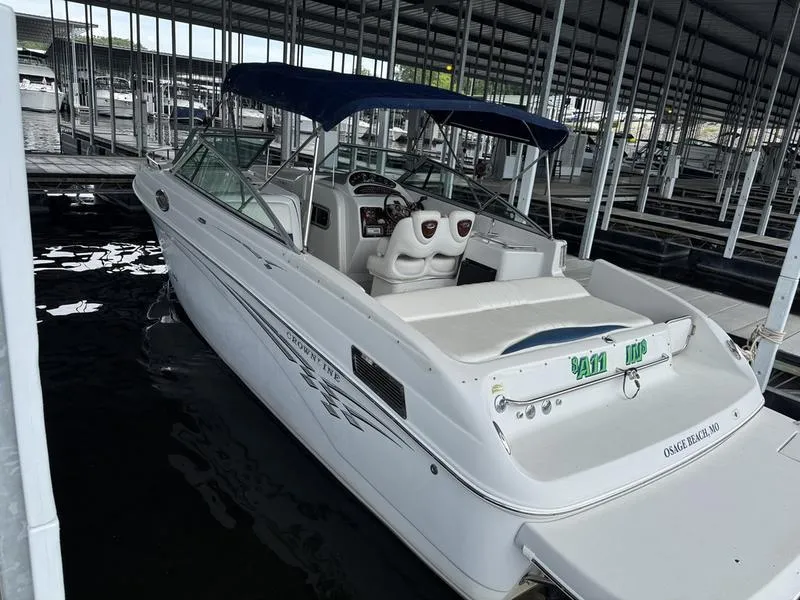 Slide: The Image of 2006 Crownline 290 BR boat docked in a marina with blue canopy. - 1