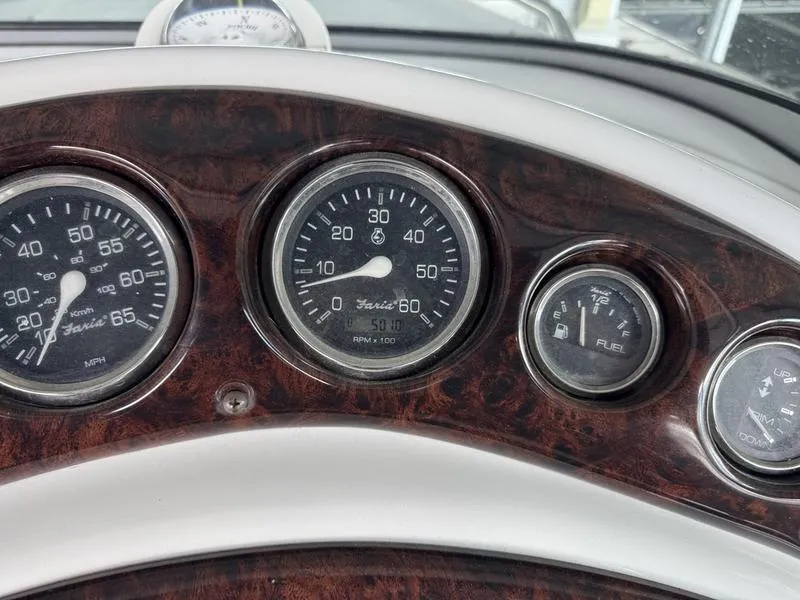 Slide: The Image of Dashboard of a 2006 Crownline 290 BR boat with speedometer and fuel gauge. - 10