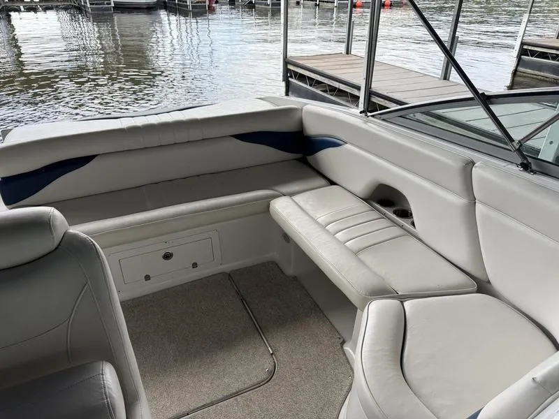 Slide: The Image of 2006 Crownline 290 BR boat interior with beige seating and waterfront view. - 11
