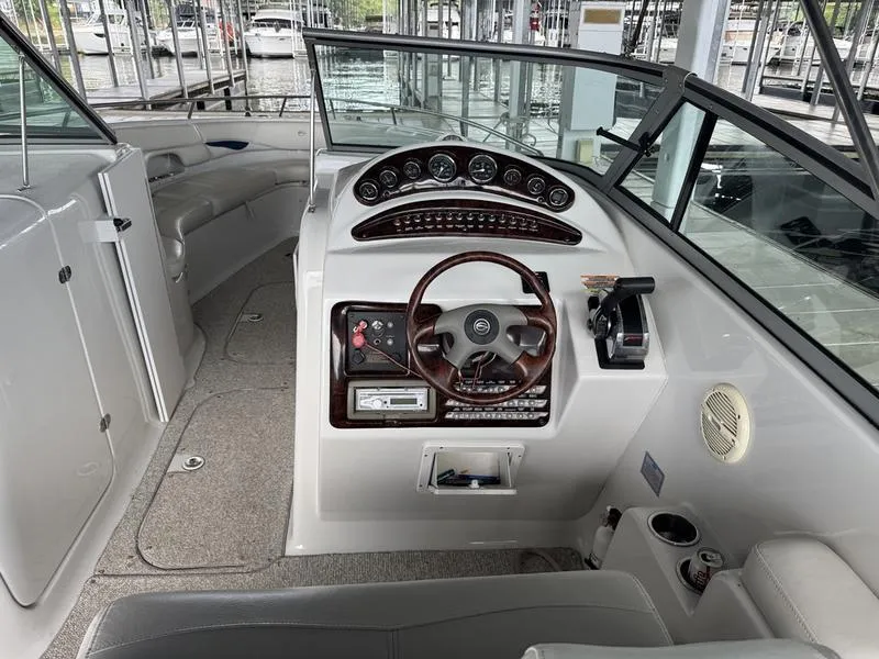 Slide: The Image of 2006 Crownline 290 BR boat interior with steering wheel and control panel. - 12