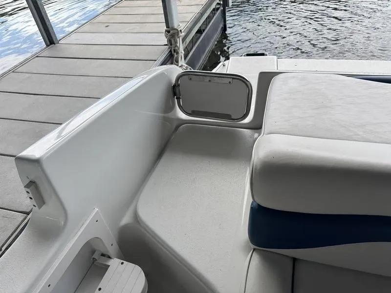 Slide: The Image of 2006 Crownline 290 BR boat interior with seating and dock view. - 14