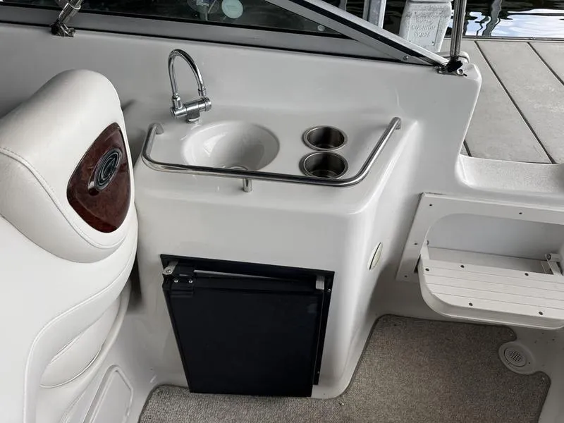 Slide: The Image of 2006 Crownline 290 BR boat interior with sink, cup holders, and seating. - 15