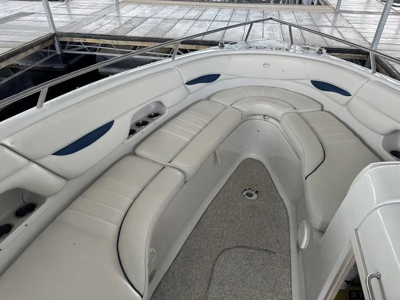 Slide: The Image of 2006 Crownline 290 BR boat interior with white seating and carpeted floor. - 18