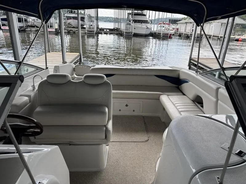 Slide: The Image of 2006 Crownline 290 BR boat interior with seating, docked at marina. - 19