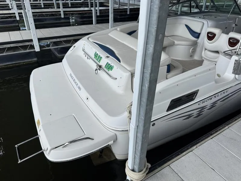 Slide: The Image of 2006 Crownline 290 BR boat docked, featuring spacious seating and sleek design. - 6
