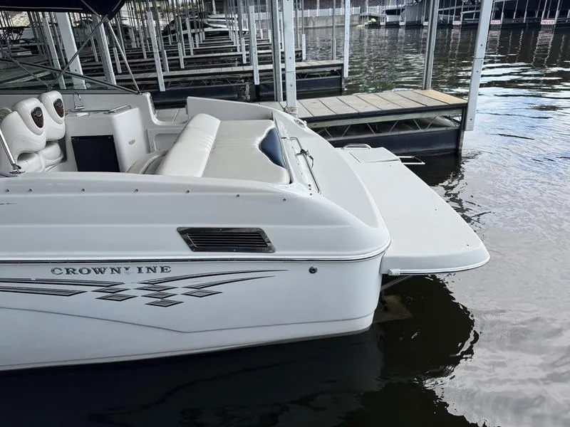 Slide: The Image of 2006 Crownline 290 BR boat docked, featuring white seating and sleek design. - 8