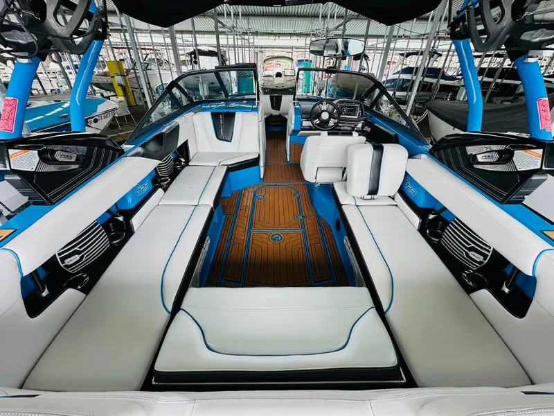 Slide: The Image of Interior of 2015 Nautique Super Air Nautique G23 boat with blue and white seating. - 13