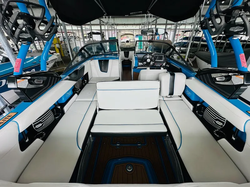 Slide: The Image of 2015 Nautique Super Air Nautique G23 interior with white seating and blue accents. - 14