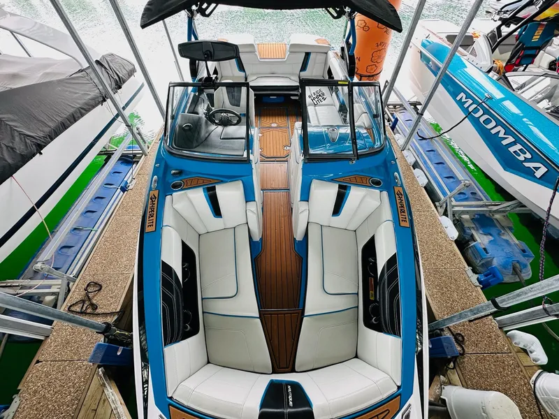 Slide: The Image of 2015 Nautique Super Air Nautique G23 boat with sleek interior and blue accents. - 15
