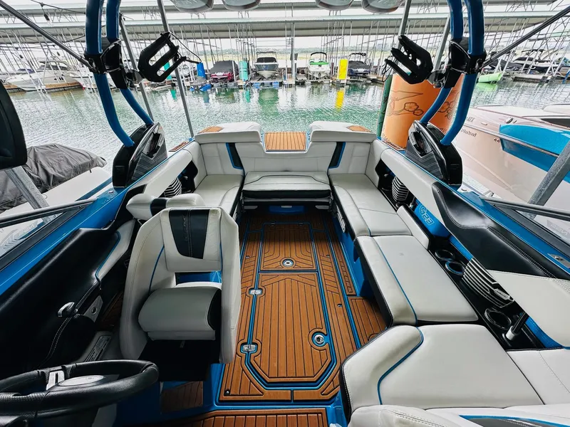 Slide: The Image of 2015 Nautique Super Air Nautique G23 interior with luxurious seating and stylish design. - 16