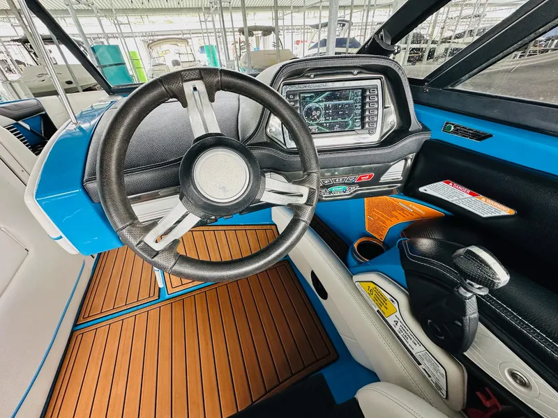 Slide: The Image of 2015 Nautique Super Air Nautique G23 dashboard with steering wheel and control panel. - 18