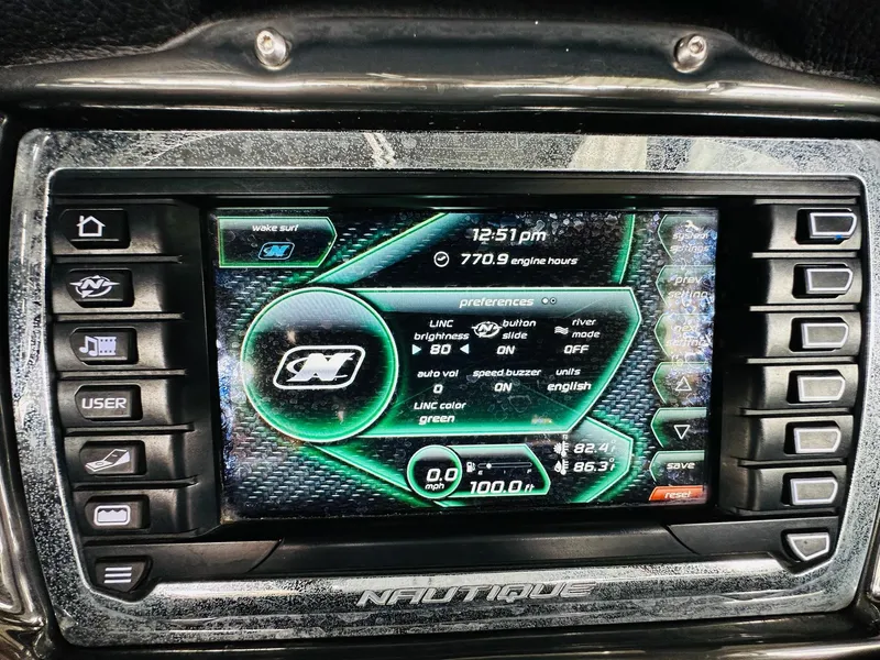 Slide: The Image of 2015 Nautique Super Air Nautique G23 dashboard display with control buttons and settings. - 19