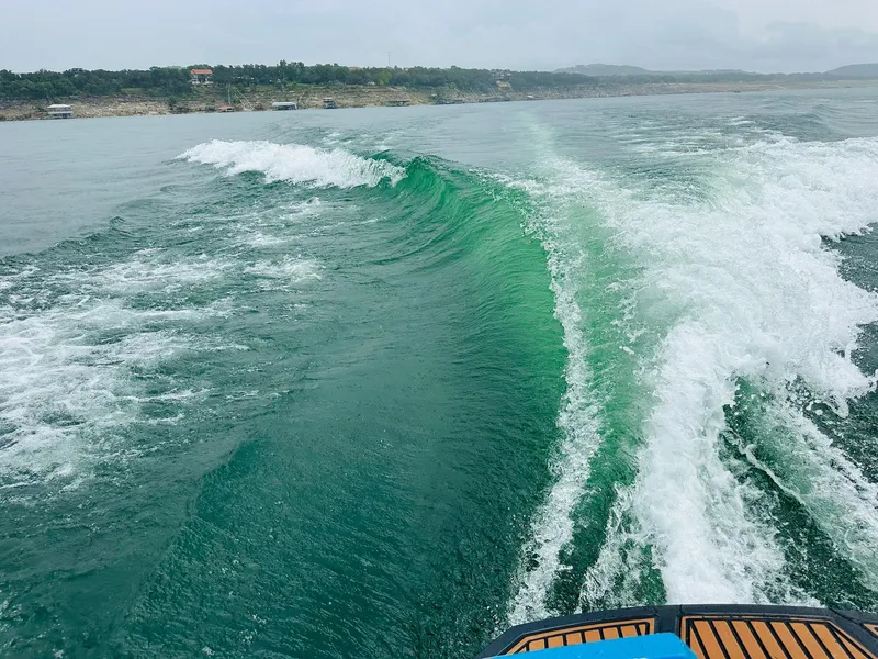 Slide: The Image of Wake created by a 2015 Nautique Super Air Nautique G23 on a scenic lake. - 23