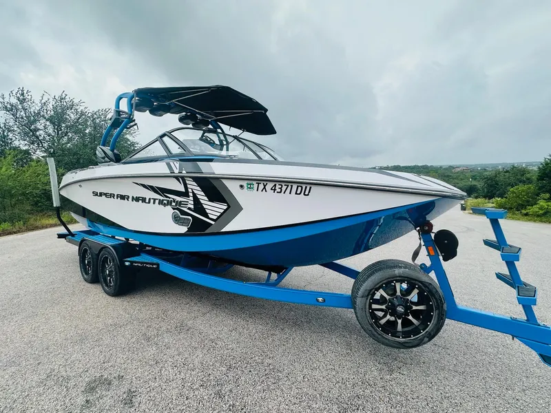 Slide: The Image of 2015 Nautique Super Air Nautique G23 boat on trailer, parked outdoors. - 6