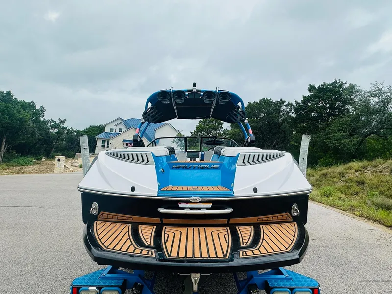 Slide: The Image of 2015 Nautique Super Air Nautique G23 boat on trailer, rear view, cloudy sky background. - 7